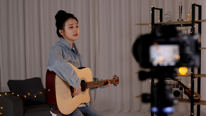 女孩录制自己吉他弹唱23秒视频
