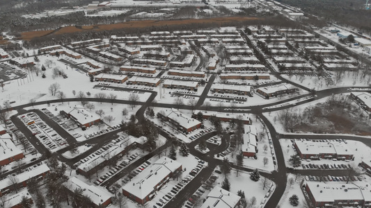 雪降后在城内街道和房屋上空飞行的空中风景视频