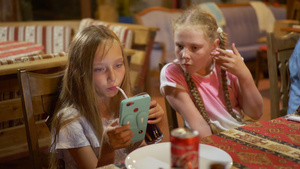 十几岁的女孩在餐桌上看智能手机使用手机观看视频的年轻8秒视频