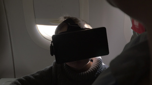 在飞机上坐着一个小男孩带着虚拟现实眼镜19秒视频