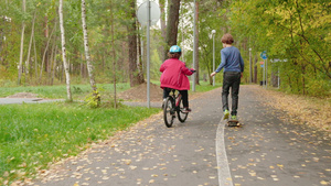 儿童在公园骑自行车和滑板后视线27秒视频