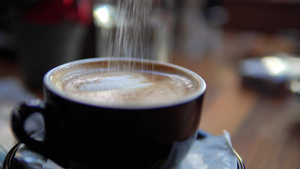 女人在咖啡店里放糖和调制卡布奇诺拿铁25秒视频