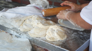 女人用擀面杖在面粉中揉面团做墨西哥玉米饼10秒视频