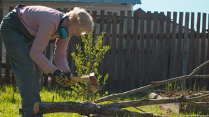在院子里的女人用斧头砍树枝30秒视频