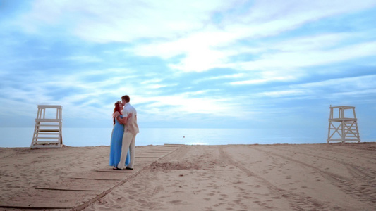 情侣在海滩上接吻情侣海滩日出怀孕夫妇视频