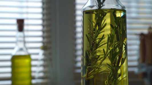 含迷迭香的橄榄油迷迭香药草落在橄榄油瓶里视频