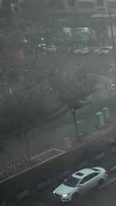 透过玻璃拍下雨天的街道城市交通视频