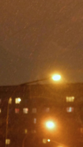 冬天寒流来临城市小巷里飘落的雪花实景拍摄城市小巷夜晚飘落的雪花视频