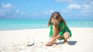 度假时在海滩上戴帽子的可爱小女孩11秒视频