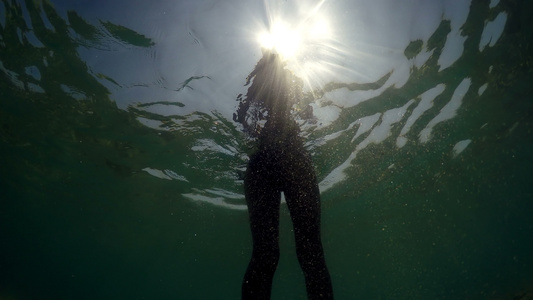 在海水中行走对抗阳光照耀从后面看水下风景的光芒视频