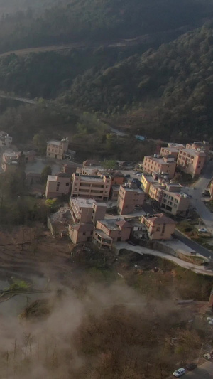 航拍日出云海下的梯田村落视频旅游观光49秒视频