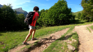在比利牛斯山上走在路上的远足女性25秒视频