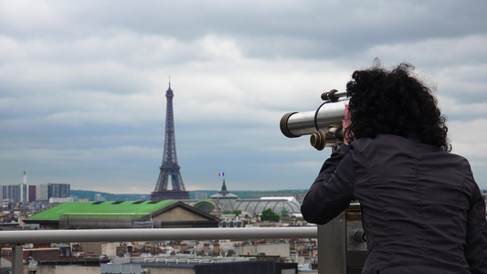 女人们用硬币操作的望远镜在肩上照相机顶部观看Parais视频