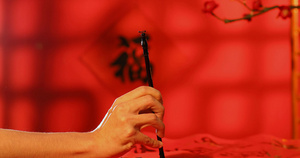 新春书法毛笔字写对联红色背景实拍视频7秒视频