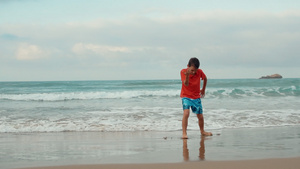 快乐的男孩在沙滩上跳舞度假21秒视频