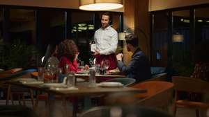 服务员在夜间餐厅晚餐约会时将酒瓶倒在花哨的情侣桌上22秒视频