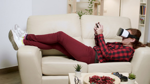 女人躺在沙发上用Vr护目镜玩电子游戏15秒视频