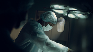 专注于在黑暗无菌医院手术室进行手术的外科医生14秒视频