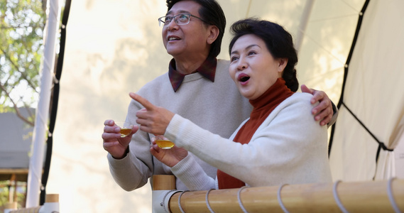 中老年夫妻搂着肩膀靠着栏杆喝茶聊天视频