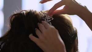 理发师为新娘做头发一个年轻女孩的婚礼发型做头发造型11秒视频
