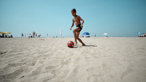 儿童在沙滩上踢足球慢动作30秒视频