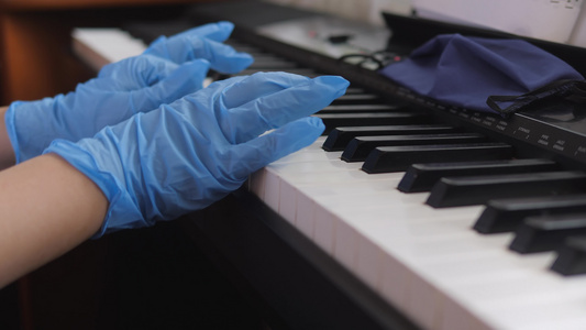 电子钢琴手指按着钢琴钥匙手握橡胶手套2020年视频