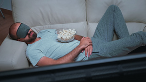 坐在沙发上看电影时睡觉的黑人男性笑声15秒视频
