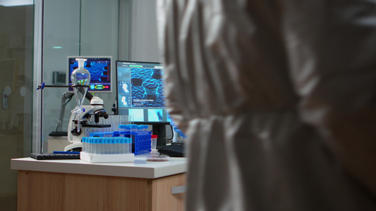 在设备齐备的实验室内有覆盖面的化学家在检查测试视频