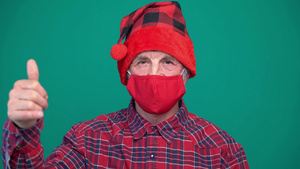 戴圣诞红帽子和红色口罩的老人9秒视频