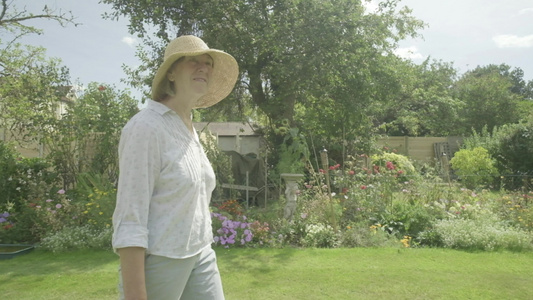 一位高级女性通过其园艺主题走动的视觉摄像头该视频