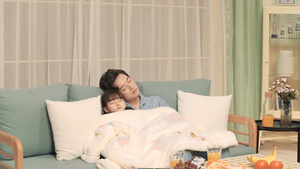妈妈为在沙发上睡着的孩子和丈夫盖毛毯20秒视频
