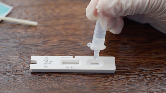 疫情下上海抗原自测将液体滴入检测卡的样本孔中视频