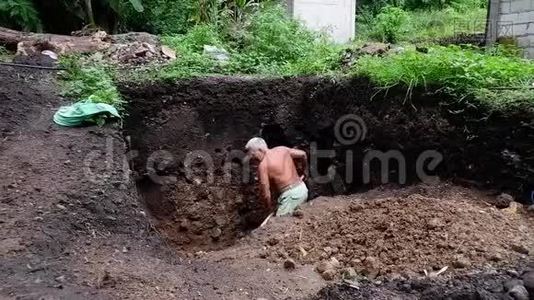 老人在他的花园里挖了个洞。视频