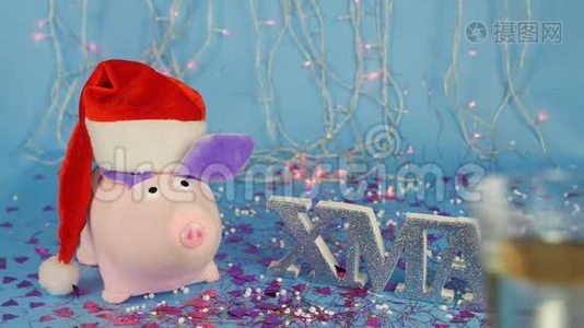 软玩具，粉红色的猪，戴着红色圣诞老人帽子，背景是一棵蓝色的圣诞树，上面写着视频