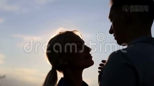两个情人在天空背景上的剪影。视频