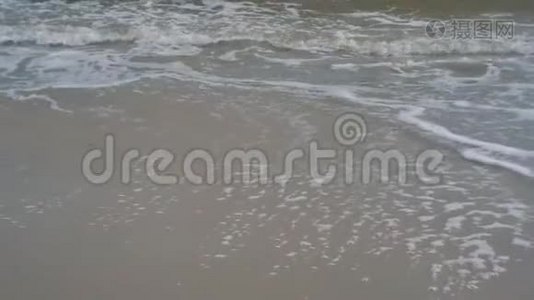 阴天时海浪拍打在沙滩上视频