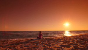 健身妇女放松后在海滩日落后景8秒视频