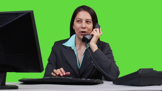年轻的商业妇女使用电脑工作同时接听电话提供咨询服务视频