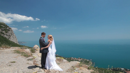 新娘和新郎在山崖上拍婚纱照视频