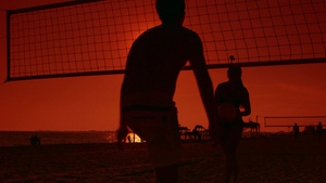 日落时在沙滩玩排球的人 13秒视频