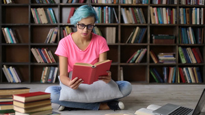 过度紧张的蓝头发大学生合上书本把眼镜戴在头上26秒视频