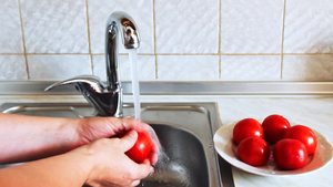 女人的手打开水龙头用水清洗西红柿12秒视频