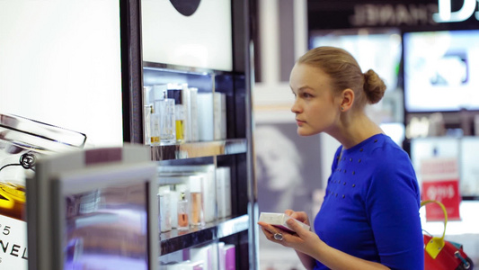年轻女性在俄罗斯莫斯科多莫杰多沃机场免税区选择香水视频
