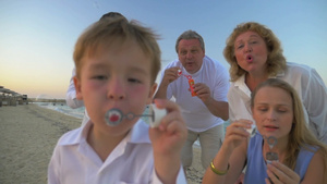 全家在海边对着镜头一起吹肥皂泡泡17秒视频