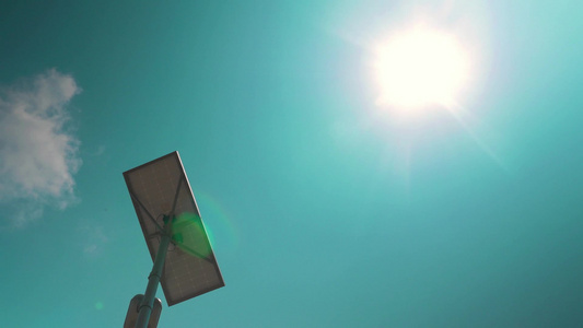 在蓝天和太阳的背景上路灯的低角度拍摄视频