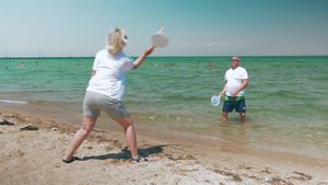 在海滩上打球的中年男女9秒视频