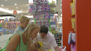 年轻的父母和儿子在超市买玩具17秒视频