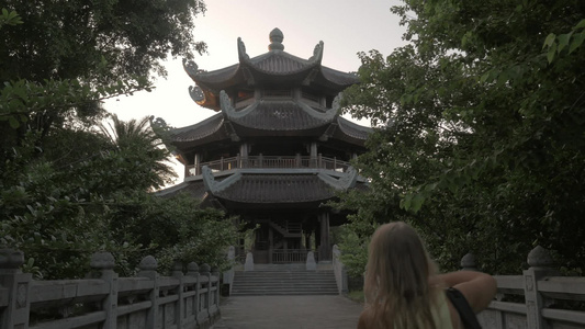女孩拿着相机拍摄越南白丁寺视频