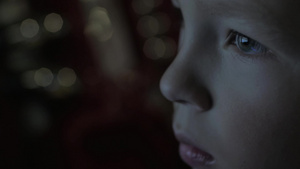 男孩脸在黑暗中与电视屏幕反射的眼睛14秒视频