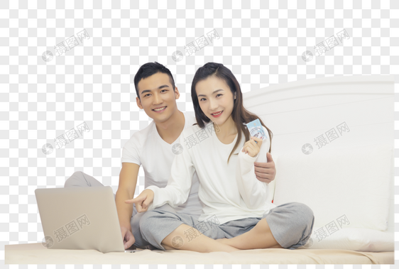 年轻夫妇在卧室用电脑购图片